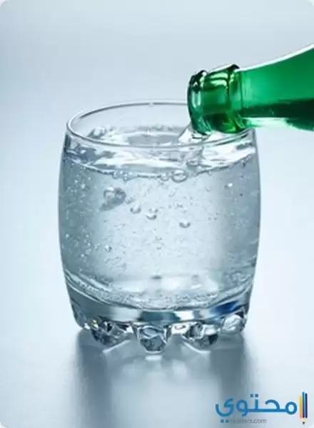 carbonated water being poured into a glass
